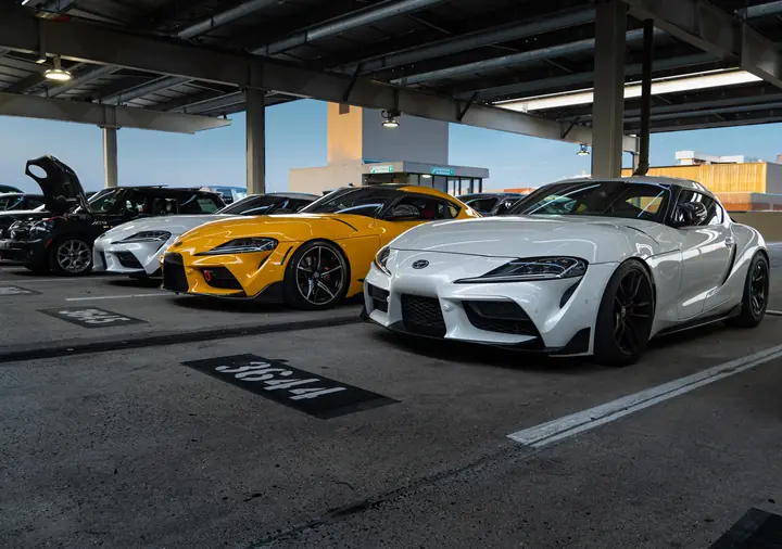 Three Supras—two white with an orange Supra in the middle