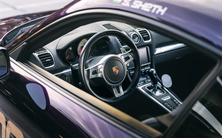 Close up of the Interior and steering wheel of a purple Porsche